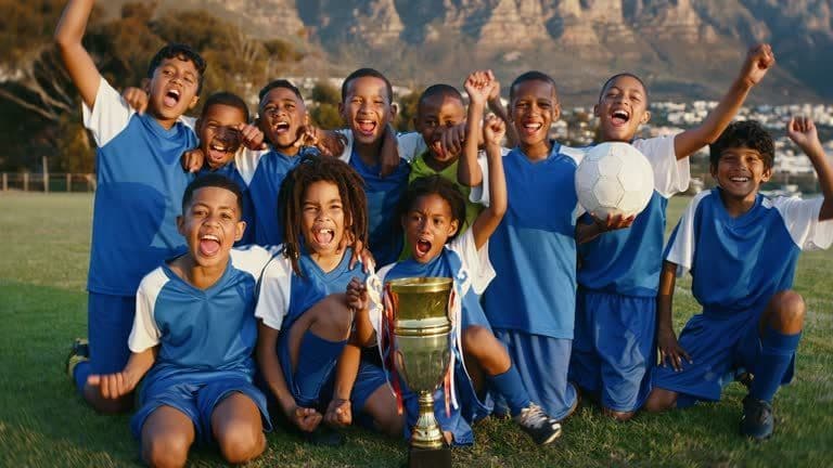 Kids lifting a trophy